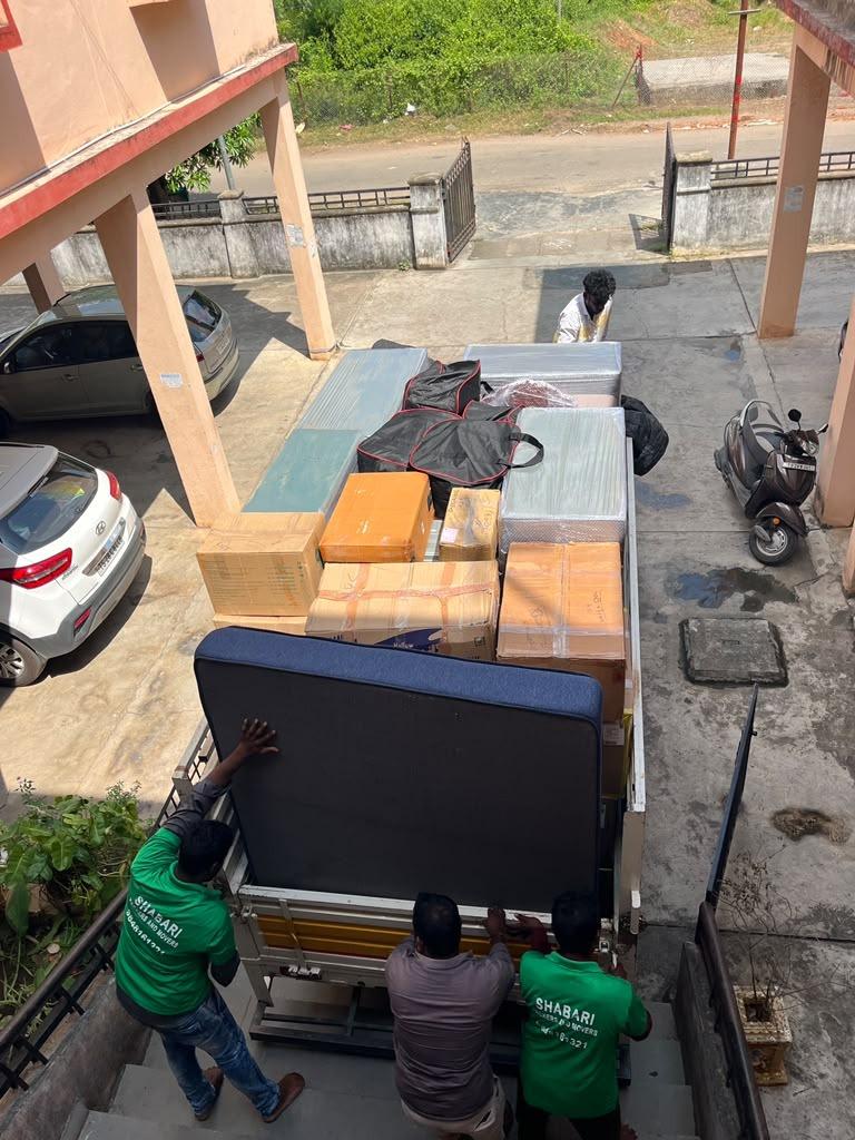 Shabari crew carefully loading heavy furniture and mattress onto truck