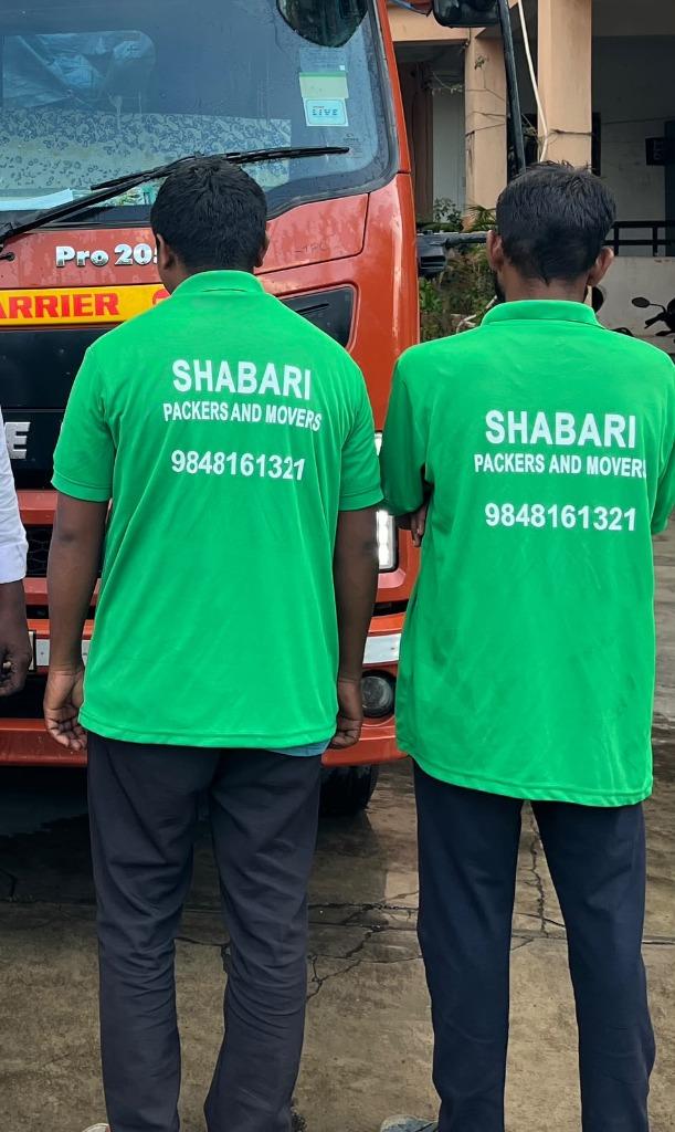 Shabari Packers and Movers team in uniform with company transport vehicle